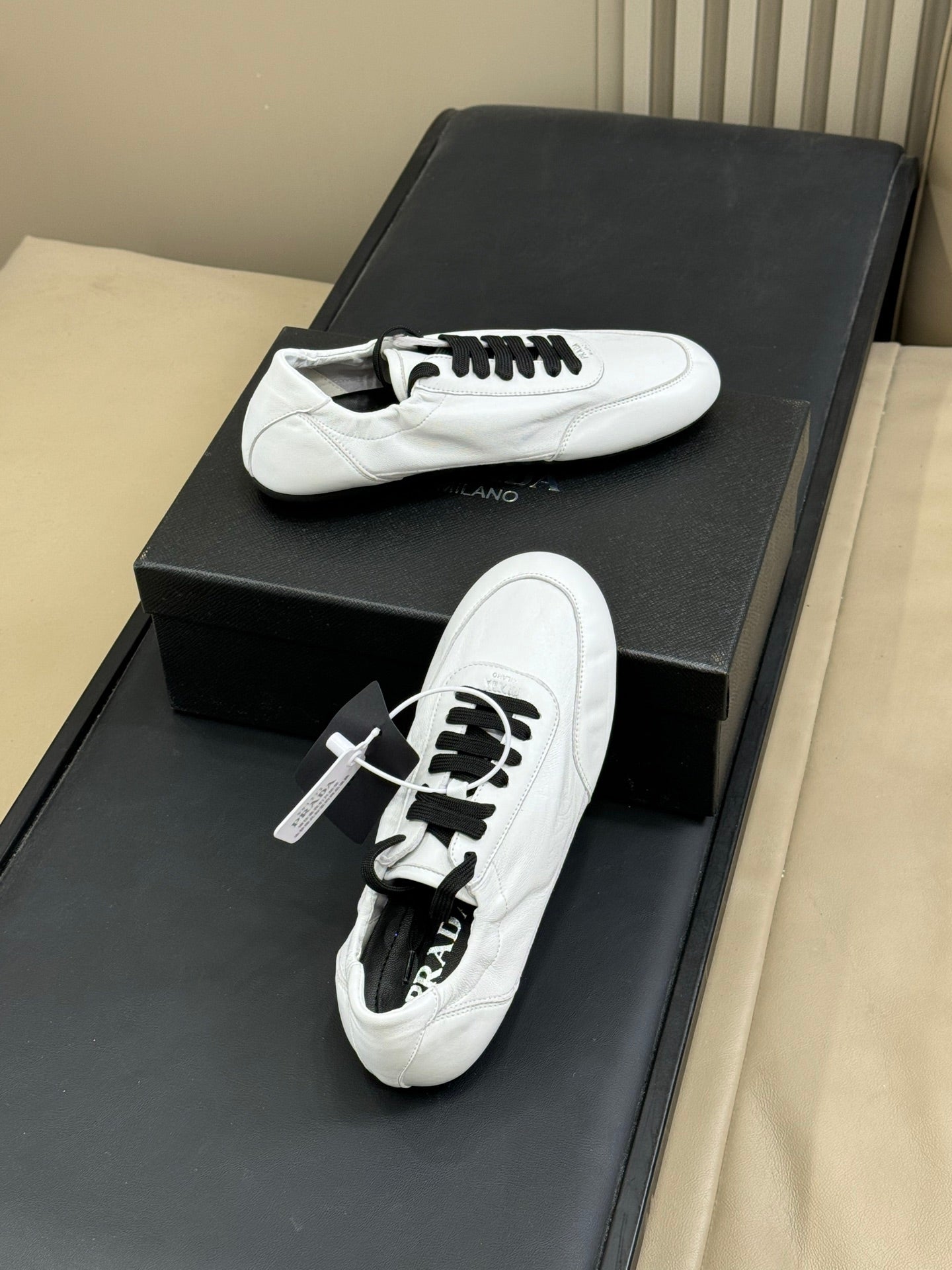 PRADA 25S COLLAPSE FLAT SHOES IN WHITE CALFSKIN