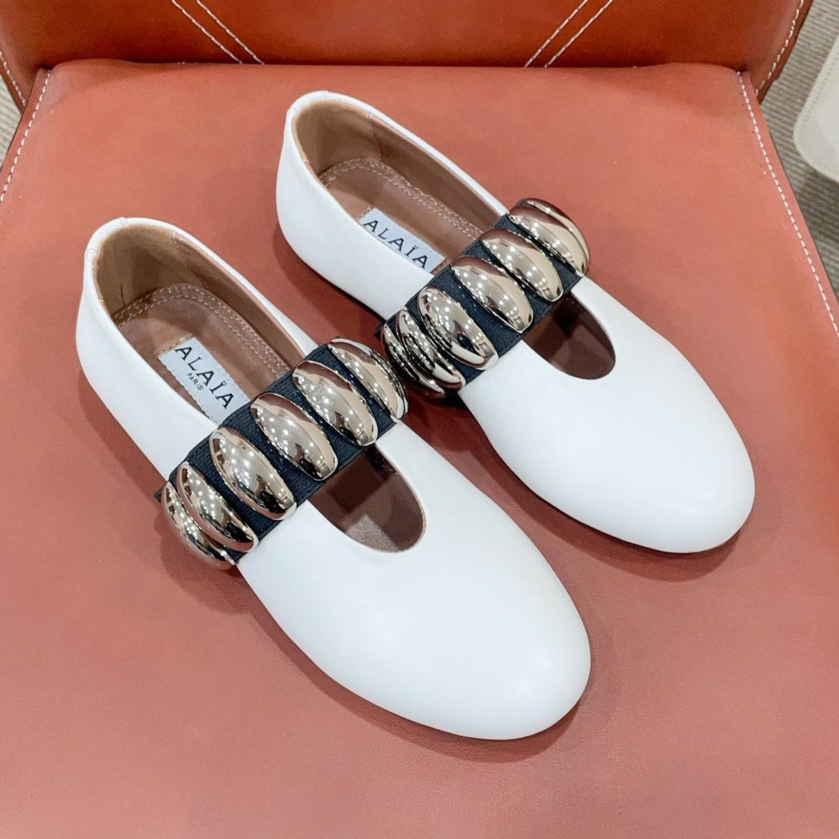 ALAIA TRIBALE BALLET FLATS IN WHITE LAMBSKIN