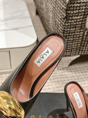 ALAIA SPIKE JEWEL MULES IN BLACK CALFSKIN WITH GOLD HARDWARE