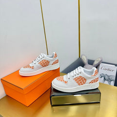 FREE SNEAKER IN WHITE CALFSKIN AND "H EN BIAIS" ORANGE CANVAS