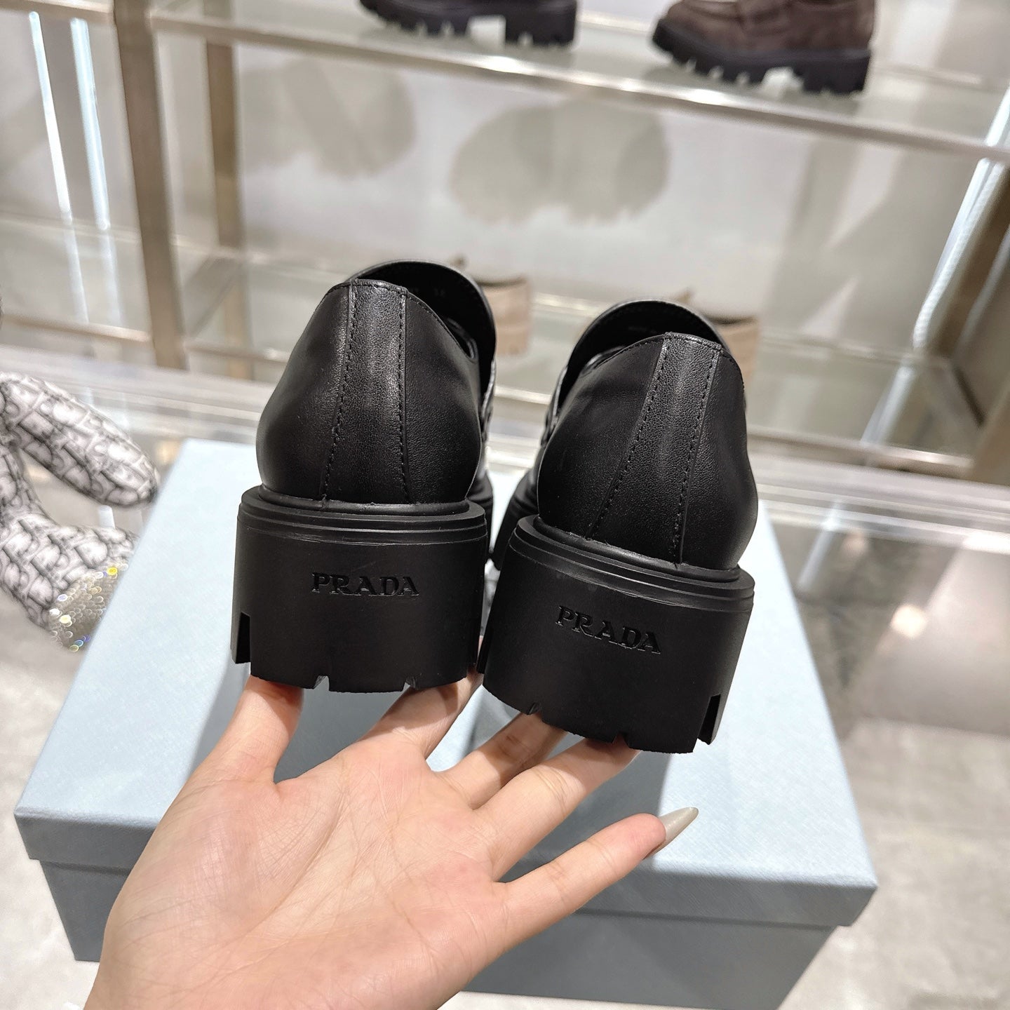 PRADA 25S THICK-SOLE LOAFERS 60 MM IN BLACK SMOOTH CALFSKIN