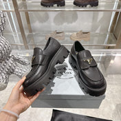 PRADA 25S THICK-SOLE LOAFERS 60 MM IN BLACK SMOOTH CALFSKIN