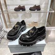 PRADA 25S THICK-SOLE LOAFERS 60 MM IN BLACK CALFSKIN
