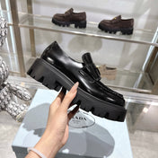 PRADA 25S THICK-SOLE LOAFERS 60 MM IN BLACK CALFSKIN