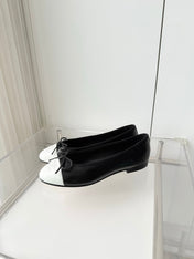 CHANEL 26S BALLET FLATS IN BLACK CRACKED CALFSKIN WITH WHITE TOE CAP AND BOW
