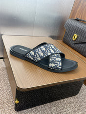 DIOR 25S ALIAS CROSS-STRAP SLIDES IN BLACK CALFSKIN WITH CD OBLIQUE DEEP BLUE LOGO