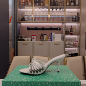 BOW-EMBELLISHED HIGH MULES IN WHITE SHEEPSKIN